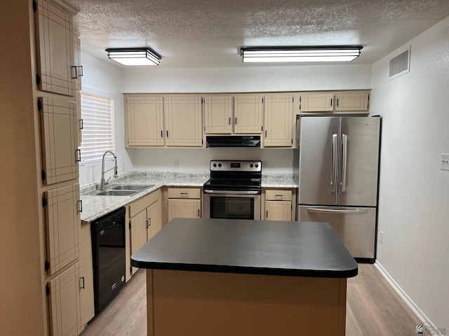 2514 W 21st St, Yuma, AZ 85364 - kitchen featuring stainless steel appliances, ventilation hood, a sink, a textured ceiling, and light wood-style floors