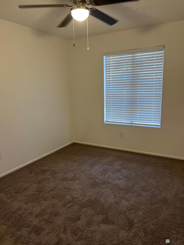 2514 W 21st St, Yuma, AZ 85364 - spare room with a ceiling fan, dark colored carpet, baseboards, and a textured ceiling