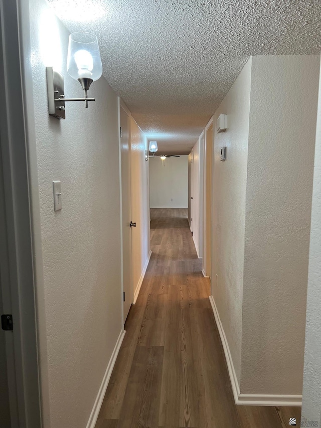 2514 W 21st St, Yuma, AZ 85364 - hallway featuring a textured wall, a textured ceiling, wood finished floors, and baseboards