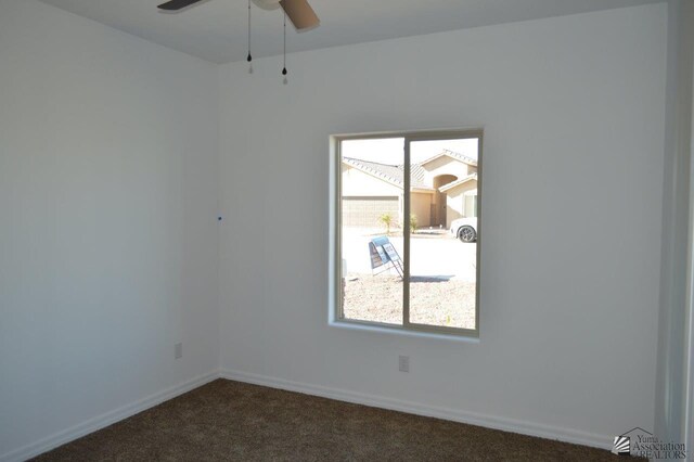 13135 E 55th Ln Lot 18, Yuma, AZ 85367 - unfurnished room with baseboards, a ceiling fan, and dark carpet