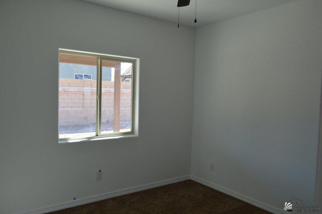 13135 E 55th Ln Lot 18, Yuma, AZ 85367 - empty room with dark colored carpet, a ceiling fan, and baseboards