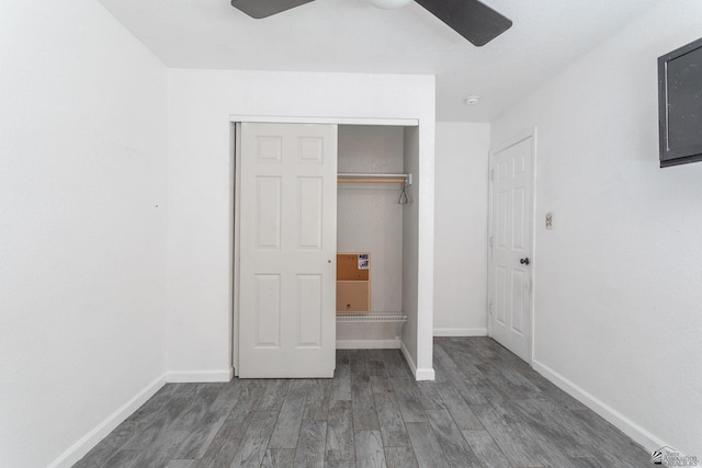 unfurnished bedroom with baseboards, a ceiling fan, a closet, and wood finished floors