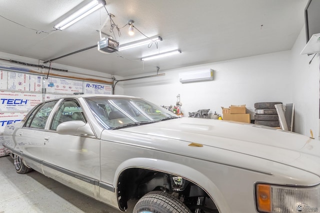 garage with a wall unit AC and a garage door opener