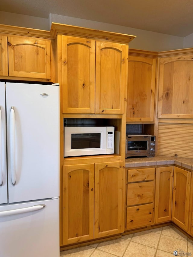 14818 E 52nd St, Yuma, AZ 85367 - kitchen featuring a toaster, tile counters, white appliances, and light tile patterned flooring