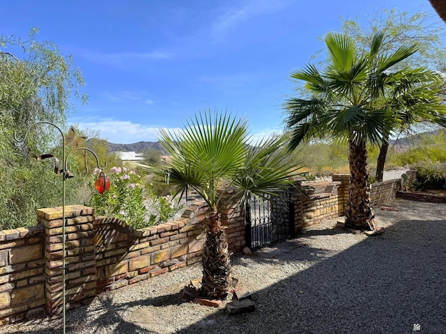 14818 E 52nd St, Yuma, AZ 85367 - view of yard with fence, a gate, and a mountain view