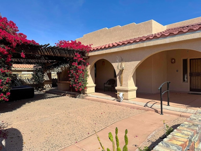 14818 E 52nd St, Yuma, AZ 85367 - view of front of home featuring a pergola, stucco siding, a patio area, and a tiled roof