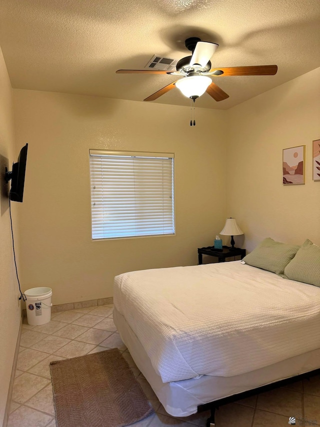 14818 E 52nd St, Yuma, AZ 85367 - bedroom with visible vents, a textured ceiling, ceiling fan, and light tile patterned floors