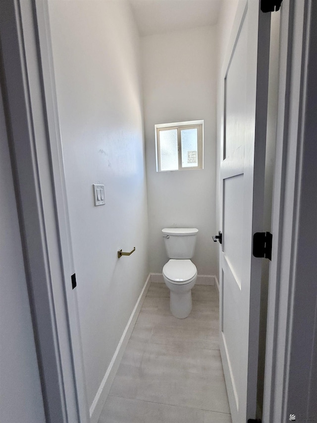 12377 W Calle Ln, Primera, Yuma, AZ 85367 - bathroom featuring toilet, baseboards, and wood finished floors