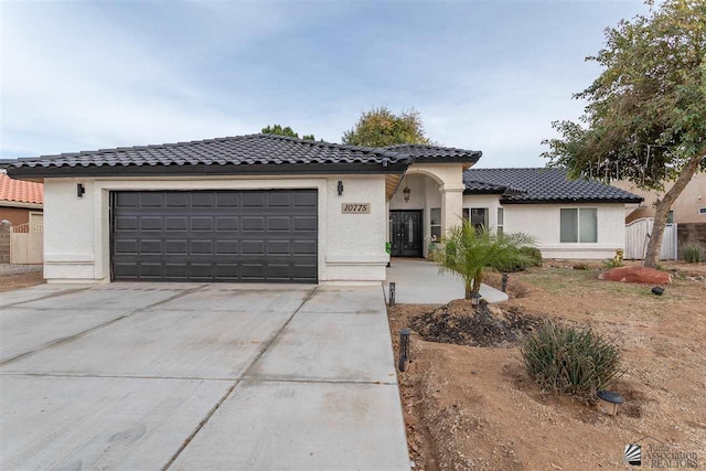 mediterranean / spanish-style home with a garage