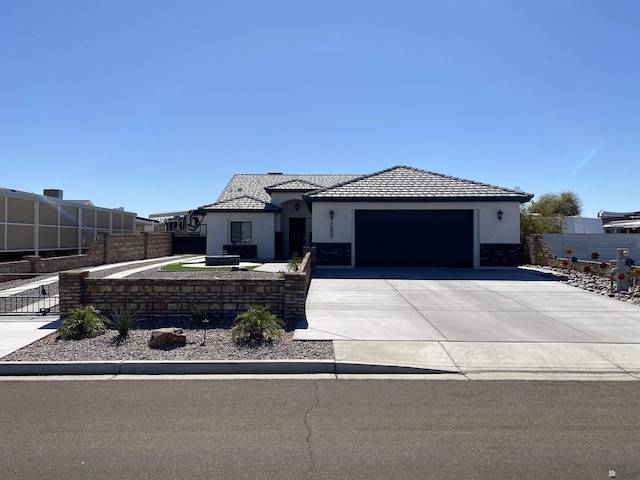 14673 E 52nd St, Yuma, AZ 85367 - view of front facade featuring fence, stucco siding, driveway, and a garage
