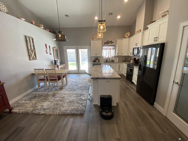 14673 E 52nd St, Yuma, AZ 85367 - kitchen featuring white cabinets, a kitchen island, black appliances, and visible vents