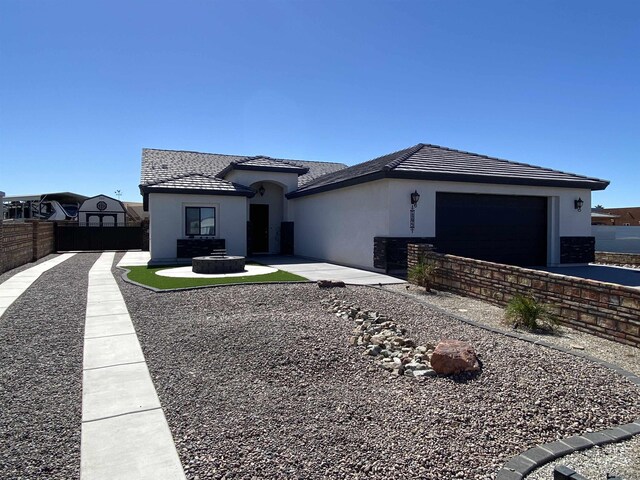 14673 E 52nd St, Yuma, AZ 85367 - view of front of house featuring an attached garage, fence, driveway, and stucco siding