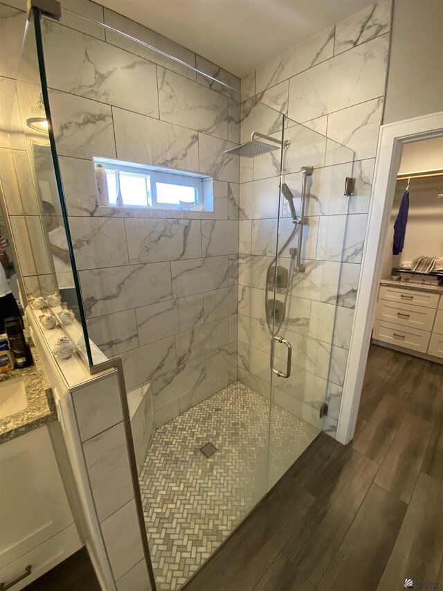 14673 E 52nd St, Yuma, AZ 85367 - full bathroom featuring vanity, a stall shower, and wood finished floors