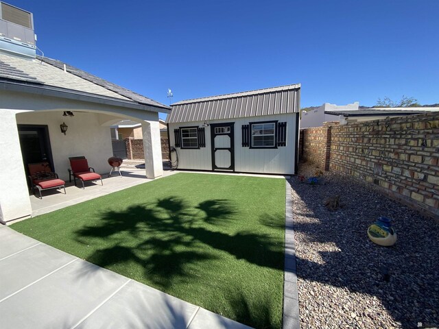 14673 E 52nd St, Yuma, AZ 85367 - rear view of property with a fenced backyard, a yard, a patio, and an outbuilding