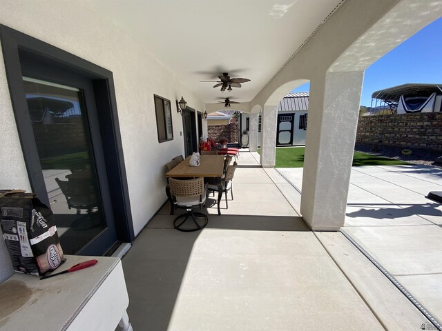 14673 E 52nd St, Yuma, AZ 85367 - view of patio with ceiling fan, an outbuilding, a fenced backyard, and outdoor dining space