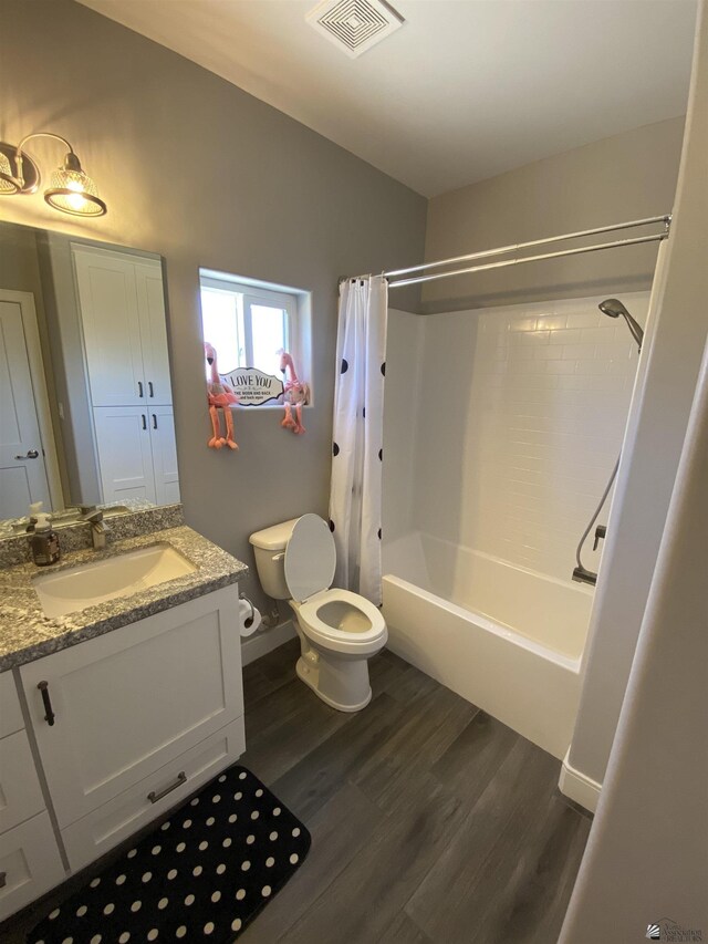14673 E 52nd St, Yuma, AZ 85367 - full bath with vanity, toilet, shower / bath combination with curtain, wood finished floors, and visible vents