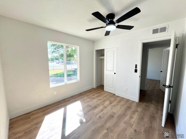 2461 S 17th Ave, Yuma, AZ 85364 - unfurnished bedroom with a closet, light wood-style flooring, and ceiling fan