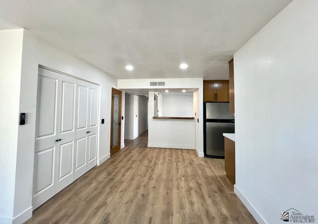 2461 S 17th Ave, Yuma, AZ 85364 - interior space with light wood-type flooring, recessed lighting, and a textured ceiling