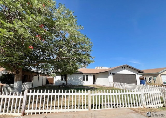 2461 S 17th Ave, Yuma, AZ 85364 - ranch-style house featuring a garage, a fenced front yard, and stucco siding