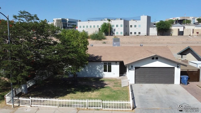 2461 S 17th Ave, Yuma, AZ 85364 - view of front facade with a garage, concrete driveway, and stucco siding
