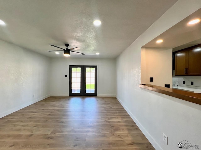 2461 S 17th Ave, Yuma, AZ 85364 - unfurnished living room with ceiling fan, recessed lighting, light wood-type flooring, and french doors