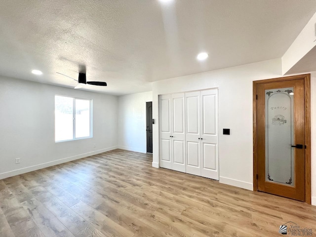 2461 S 17th Ave, Yuma, AZ 85364 - unfurnished bedroom featuring light wood finished floors, a textured ceiling, ceiling fan, recessed lighting, and a closet