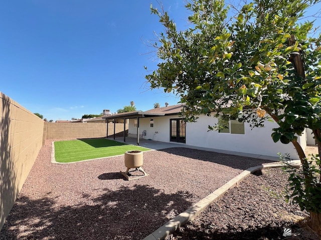 2461 S 17th Ave, Yuma, AZ 85364 - rear view of house featuring french doors, a fenced backyard, a patio, and stucco siding