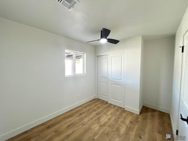 2461 S 17th Ave, Yuma, AZ 85364 - unfurnished bedroom with a closet, light wood-style floors, and a ceiling fan