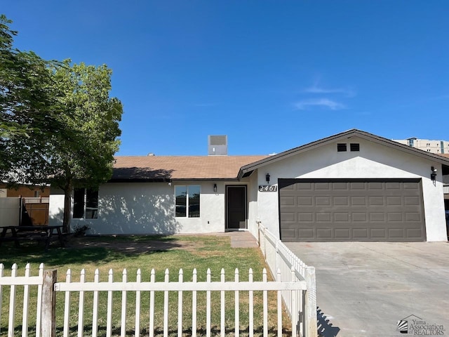 2461 S 17th Ave, Yuma, AZ 85364 - ranch-style home featuring stucco siding, an attached garage, and driveway