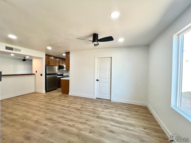 2461 S 17th Ave, Yuma, AZ 85364 - unfurnished living room with a ceiling fan, light wood-style floors, recessed lighting, and a textured ceiling