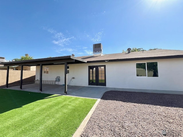 2461 S 17th Ave, Yuma, AZ 85364 - back of property with french doors, a patio area, and stucco siding