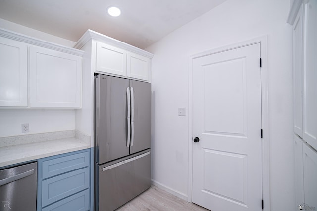 1911 W 18th St, Yuma, AZ 85364 - kitchen with baseboards, light wood-type flooring, recessed lighting, white cabinetry, and stainless steel appliances