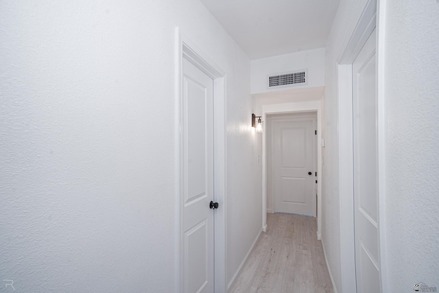 1911 W 18th St, Yuma, AZ 85364 - corridor with baseboards, light wood finished floors, and visible vents