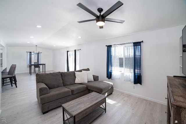 1911 W 18th St, Yuma, AZ 85364 - living area with light wood-type flooring, ceiling fan with notable chandelier, lofted ceiling, and a healthy amount of sunlight