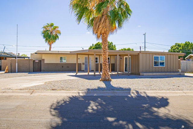 1911 W 18th St, Yuma, AZ 85364 - ranch-style house with fence, brick siding, board and batten siding, concrete driveway, and a carport