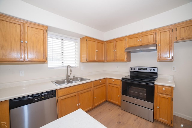 2794 W 27th Ln, Yuma, AZ 85364 - kitchen featuring appliances with stainless steel finishes, under cabinet range hood, light wood finished floors, light countertops, and brown cabinetry