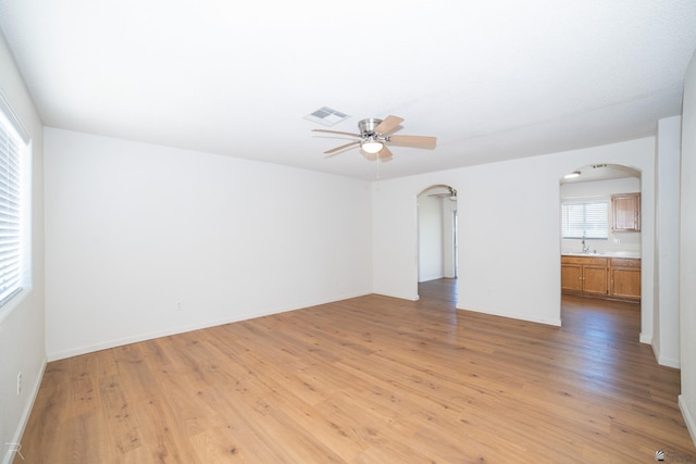 2794 W 27th Ln, Yuma, AZ 85364 - unfurnished room featuring arched walkways, ceiling fan, and light wood-style floors