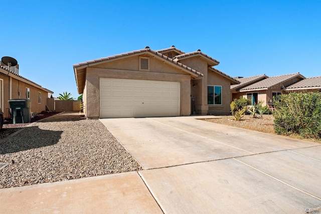 4841 W 10th Pl, Yuma, AZ 85364 - view of front of property with a garage, concrete driveway, stucco siding, and a tiled roof