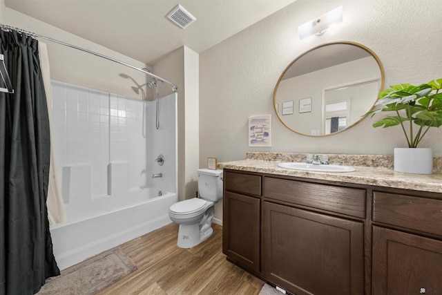 4841 W 10th Pl, Yuma, AZ 85364 - bathroom with wood finished floors, vanity, shower / bath combo with shower curtain, and a textured wall
