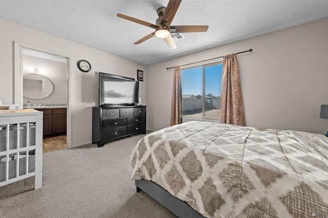 4841 W 10th Pl, Yuma, AZ 85364 - bedroom with a textured ceiling, light carpet, ensuite bathroom, and ceiling fan