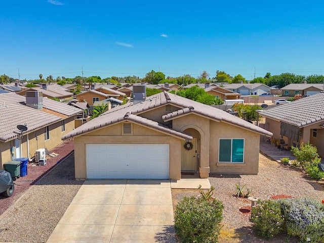 4841 W 10th Pl, Yuma, AZ 85364 - view of front of house with a residential view, driveway, stucco siding, and a garage