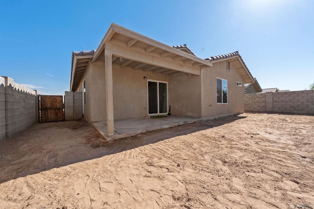 4841 W 10th Pl, Yuma, AZ 85364 - back of property featuring a gate, a fenced backyard, stucco siding, and a patio area