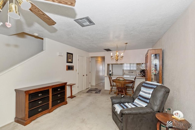 2901 S Palo Verde Ln # 38, Yuma, AZ 85364 - living area with a chandelier, light carpet, and a textured ceiling