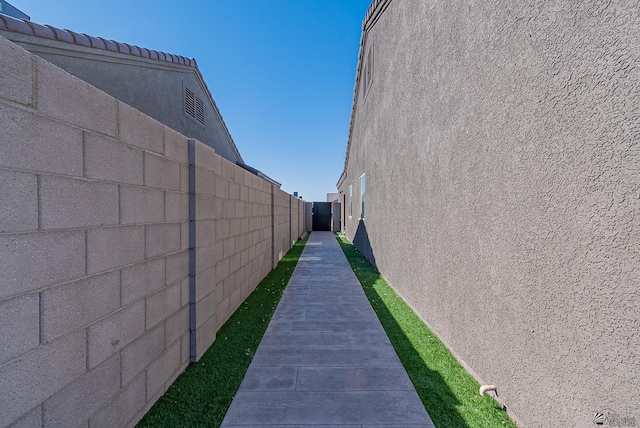 view of home's exterior with stucco siding and fence