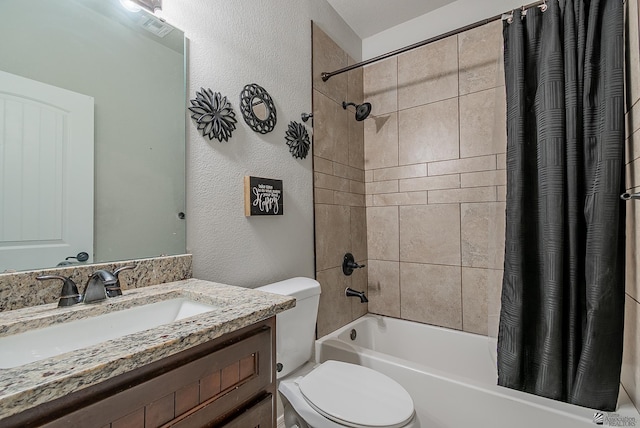 full bathroom with shower / bath combo with shower curtain, a textured wall, toilet, and vanity