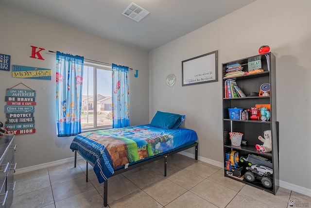 bedroom featuring light tile patterned flooring, baseboards, and visible vents