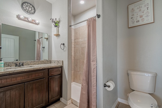 full bath with toilet, tile patterned floors, baseboards, and vanity