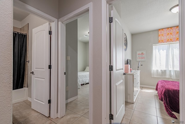 interior space with light tile patterned flooring and baseboards