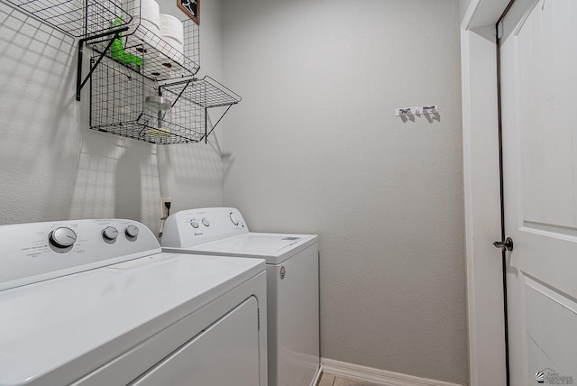 laundry area featuring baseboards, laundry area, and washer and dryer