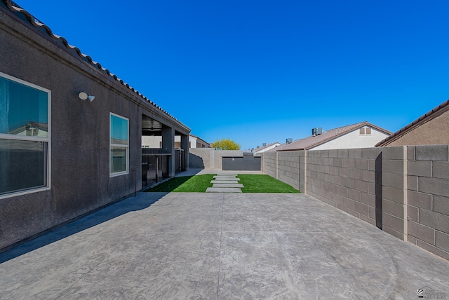 exterior space with a fenced backyard and a patio area